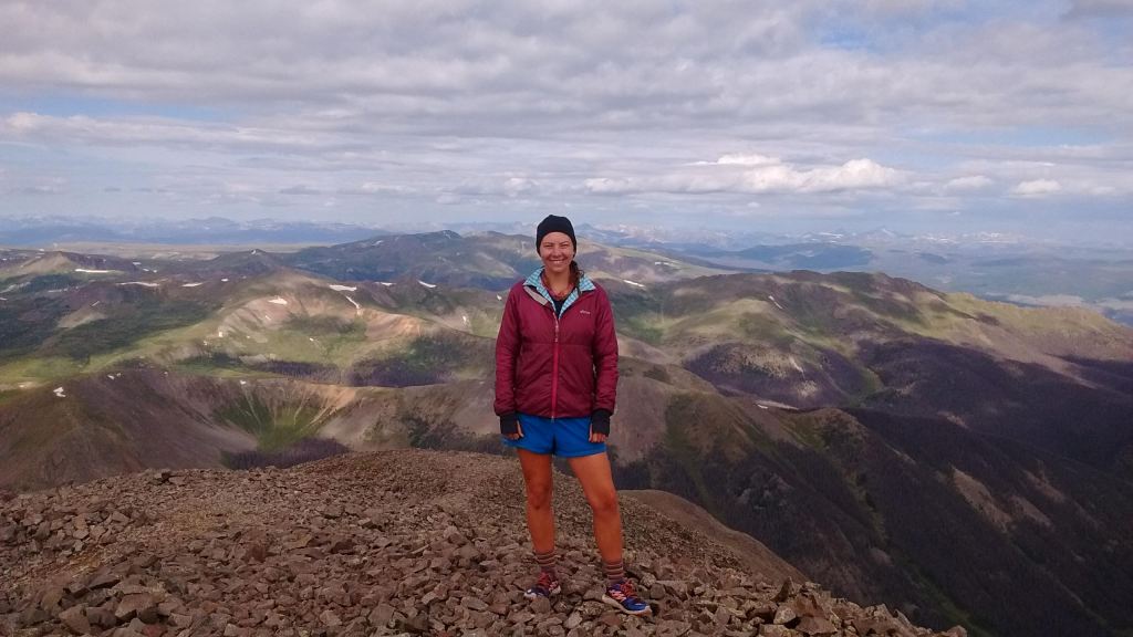 A hiker standing on top of a mountain