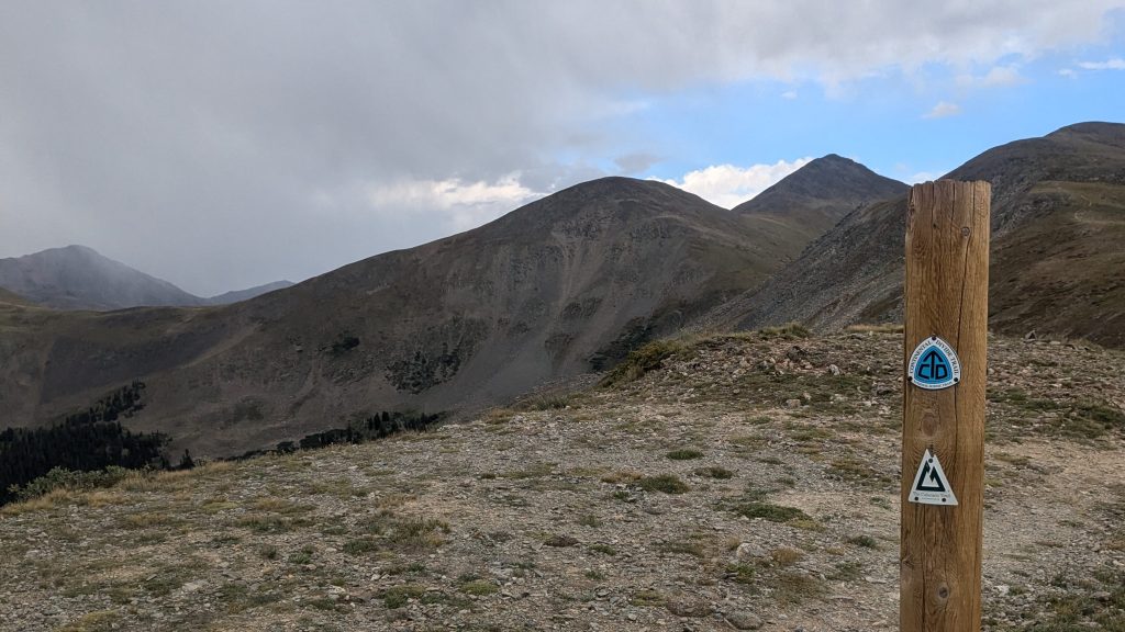 A signpost with the Colorado Trail and Continental Divide Trail markers