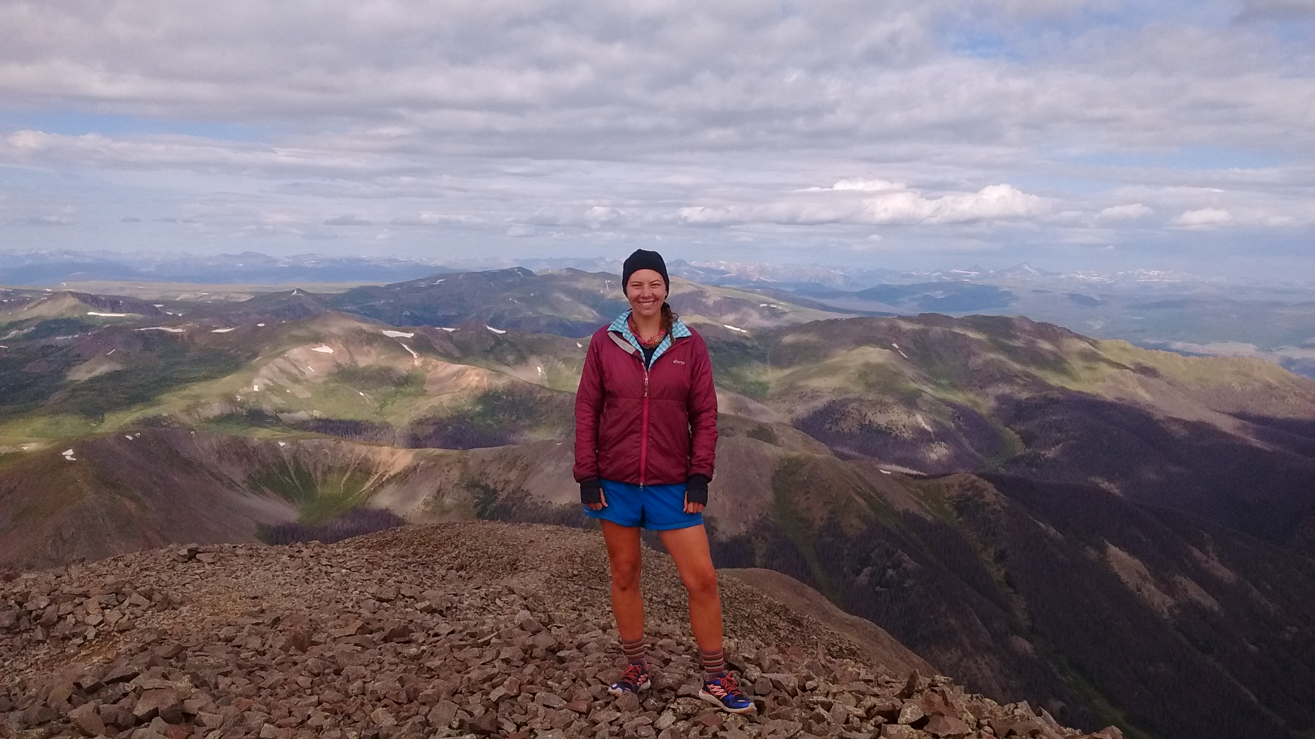 Woman standing on a mountain top